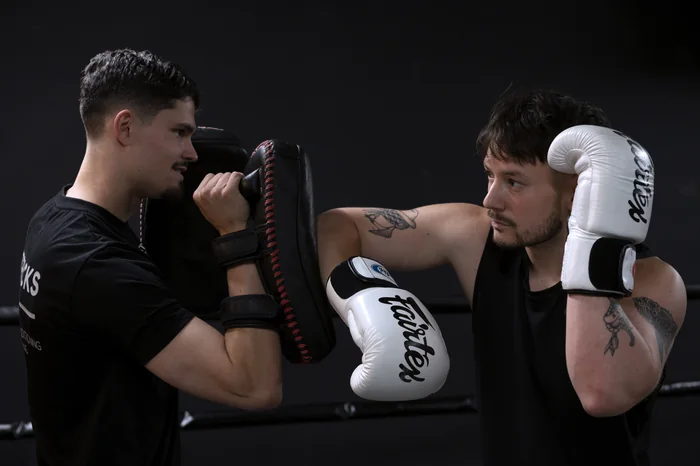 Elbow strike on the pads, seen from the side